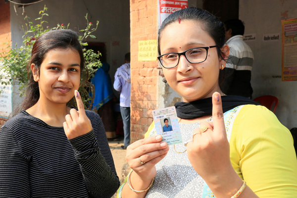 PALAMU, NOV 30 (UNI):-Ladies showing their inked finger after casting his vote during during 1st phase of Assembly Election at, in Palamu on Saturday. UNI PHOTO-54U