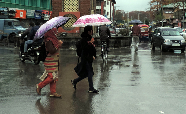 SRINAGAR, NOV 6 (UNI) Women with Umbrellas walking down the capital city Lal Chowk amid rainfall and spontaneous general strike on the 94th consecutive day on Wednesday. UNI SRN PHOTO 3