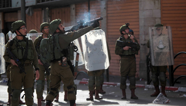 HEBRON, Nov. 26 (Xinhua) -- An Israeli soldier fires a tear gas canister at Palestinians during a protest against the latest remarks by U.S. Secretary of State Mike Pompeo on the legality of Israeli settlements in the West Bank, in Hebron, Nov. 26, 2019. Xinhua/UNI PHOTO-9F