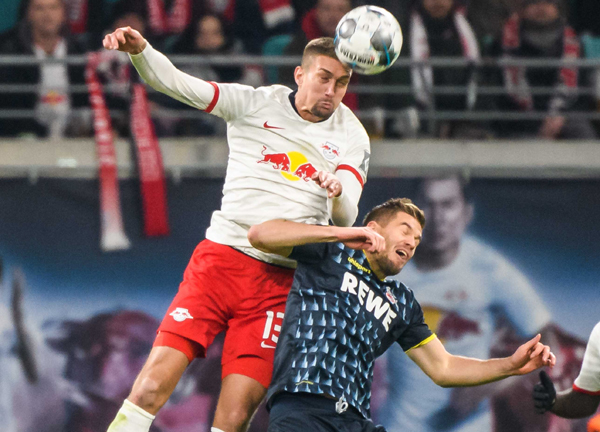 LEIPZIG, Nov. 24 (Xinhua) -- Stefan Ilsanker (top) of Leipzig vies for header with Simon Terodde of Koeln during a German Bundesliga match between RB Leipzig and 1.FC Koeln in Leipzig, Germany, on Nov. 23, 2019. Xinhua/UNI PHOTO-1F