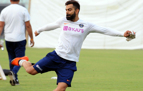 Virat Kohli warming up at Eden Gardens on the eve of the historic pink ball test