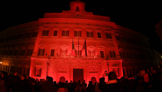 ROME, Nov. 26 (Xinhua) -- People gather in front of the Palazzo Montecitorio illuminated in red to mark the International Day for the Elimination of Violence Against Women in Rome, Italy, on Nov. 25, 2019. Several events were held in Italy to mark the International Day for the Elimination of Violence Against Women, which was marked worldwide on Monday. Xinhua/ UNI PHOTO-3F