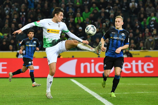 (191219) -- MONCHENGLADBACH, Dec. 19, 2019 (Xinhua) -- Florian Neuhaus (Front) of Monchengladbach competes during a German Bundesliga match between Borussia Monchengladbach and SC Paderborn 07 in Monchengladbach, Germany, Dec. 18, 2019. (Photo by Ulrich Hufnagel/Xinhua)