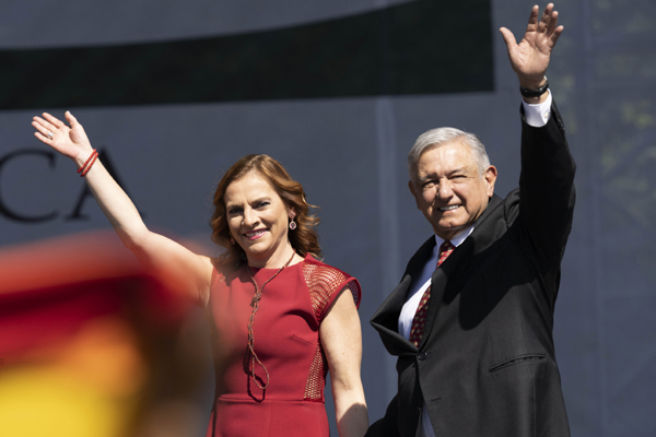 MEXICO CITY, Dec. 2, 2019 (Xinhua) -- Mexican President Andres Manuel Lopez Obrador (R) greets his supporters accompanied by his wife Beatriz Gutierrez Muller during a ceremony marking his first full year in office in Mexico City, capital of Mexico, on Dec. 1, 2019. Decreasing Mexico's high rates of violent crime is the government's main challenge, President Andres Manuel Lopez Obrador said on Sunday. Xinhua/UNI PHOTO-1F