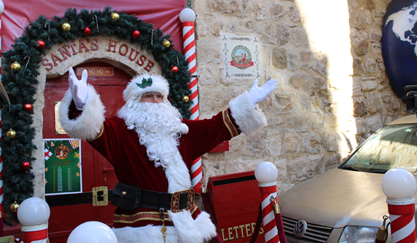 (191219) -- JERUSALEM, Dec. 19, 2019 (Xinhua) -- The "Jerusalem Santa", a Palestinian dressed up as Santa Claus, gestures outside his Santa's House in the Jerusalem's Old City on Dec. 19, 2019, as people around the world prepare to celebrate the festival. (Xinhua/Shang Hao)