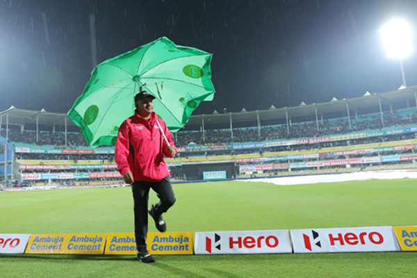 Guwahati: Umpire Virender Sharma holds an umbrella as he inspects the outfield after rains delays the start of 1st T20I match between India and Sri Lanka at Barsapara Cricket Stadium in Guwahati on Jan 5, 2020. (Photo: IANS)