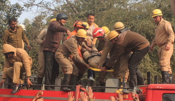 New Delhi: The body of a firefighter who succumbed to injuries after he got trapped under the debris for about 9 hours at a battery manufacturing factory which caught fire, in Outer Delhi's Mundka area on Jan 2, 2020. Balyan was a resident of Shahdhra and he was the last man brought out from the collapsed building. After nine hour long rescue operation by the Delhi Fire Service and the NDRF, 18 people including 15 firefighters have been rescued (Photo: IANS)