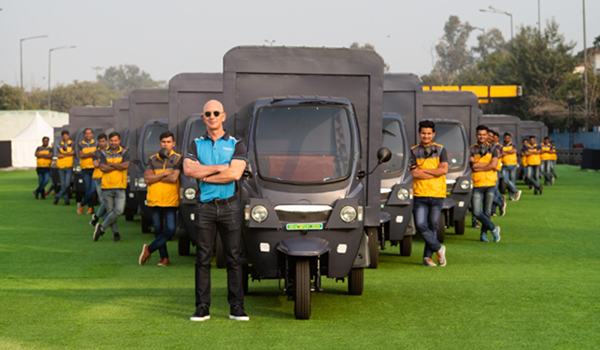 Bengaluru: Amazon founder Jeff Bezos flanked by the company's Indian delivery boys and electric vehicles during his recent visit. E-commerce giant Amazon India will deploy 10,000 electric vehicles (EVs) in its delivery fleet by 2025, the company said on Monday. (Photo: IANS)