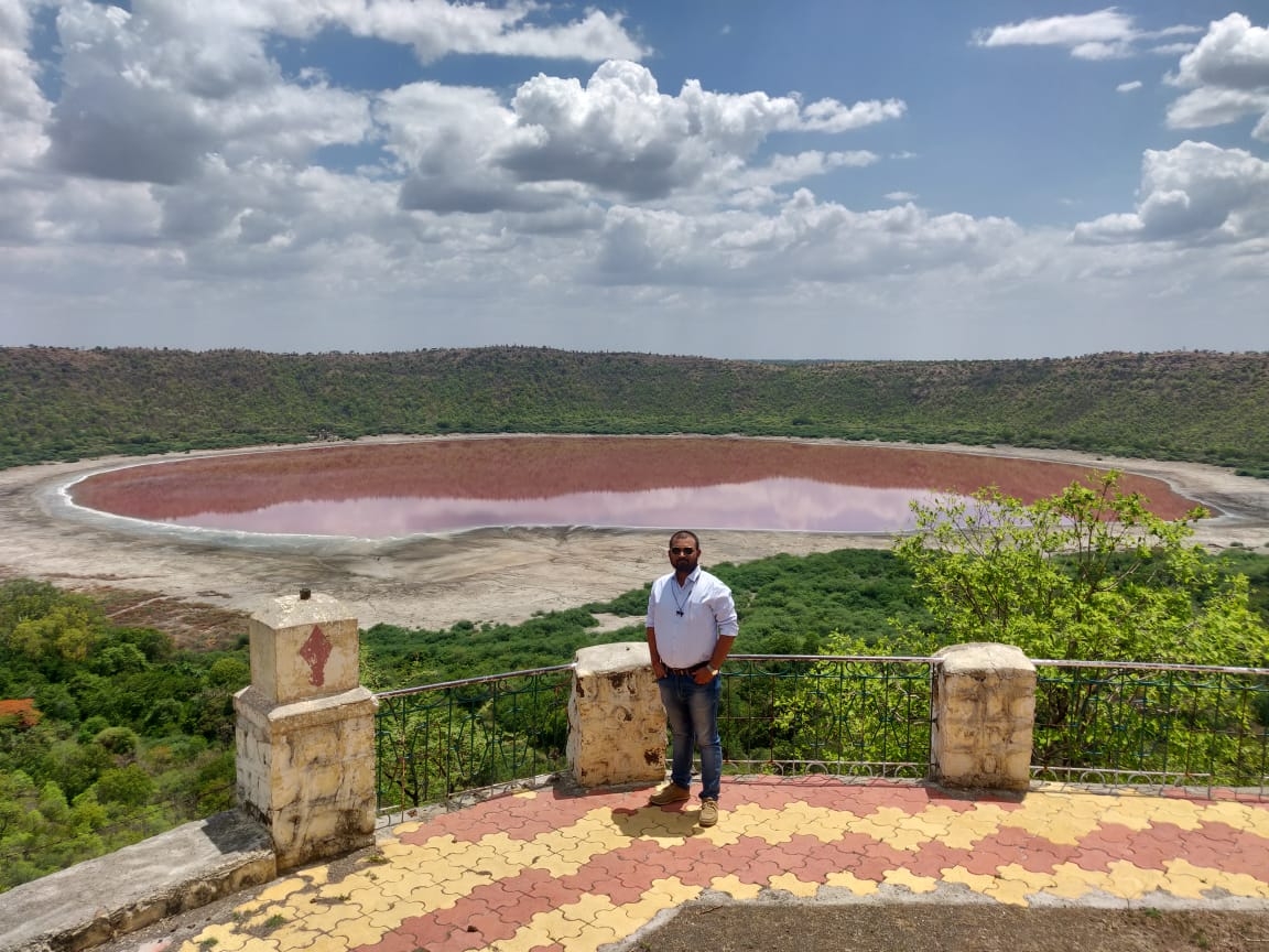 Buldhana: The world famous Lonar Lake, formed by a high velocity impact of a celestial body around 57,000 years ago, has changed colours from bluish-green to a bright baby-pink shade, astounding all, says Buldhana Tehsildar Saipan Nadaf. (Photo: IANS)