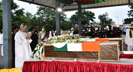 Bhubaneswar: Odisha Chief Minister Naveen Patnaik pays tributes to Chandrakant Pradhan and Naib Subedar Nanduram Soren, two Indian Army jawans from Odisha, who were killed during a clash with Chinese soldiers in Ladakh; at the Biju Patnaik International Airport in Bhubaneswar on June 18, 2020. (Photo: IANS)