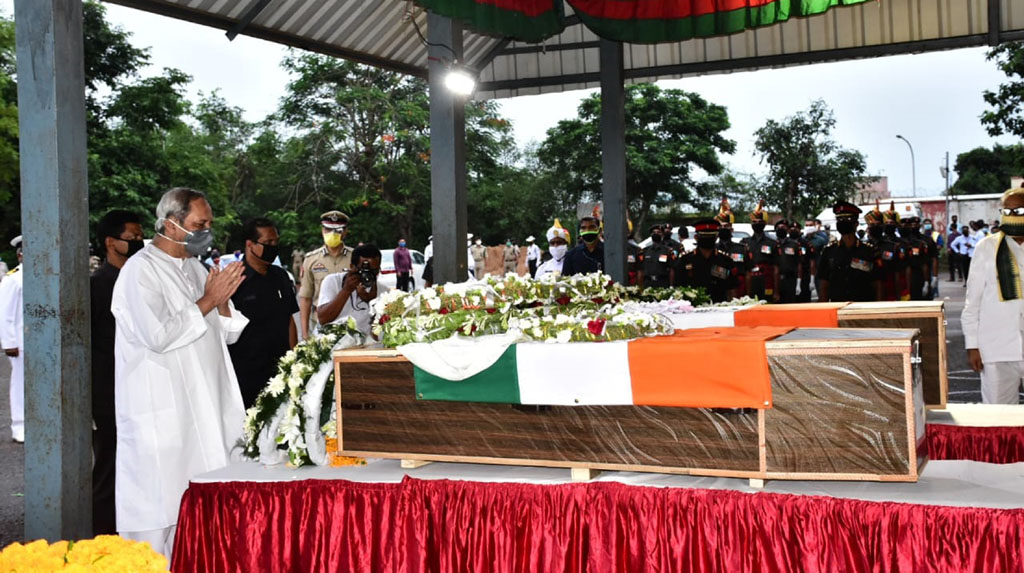 Bhubaneswar: Odisha Chief Minister Naveen Patnaik pays tributes to Chandrakant Pradhan and Naib Subedar Nanduram Soren, two Indian Army jawans from Odisha, who were killed during a clash with Chinese soldiers in Ladakh; at the Biju Patnaik International Airport in Bhubaneswar on June 18, 2020. (Photo: IANS)