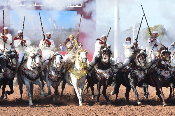 EL JADIDA (MOROCCO), Oct. 19, 2019 (Xinhua) -- Moroccan men in traditional costumes ride horses during a Fantasia horse competition at the 12th edition of the Salon du Cheval, Morocco's flagship horse exhibition, in El Jadida, Morocco, on Oct. 18, 2019. (Photo by Chadi/Xinhua/UNI PHOTO-4F