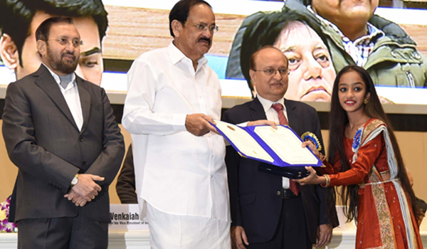 New Delhi: Vice President M. Venkaiah Naidu presents the Rajat Kamal Award to child actress Prapti Mehta for the Special Jury Award: Hellaro, at the 66th National Film Awards function, in New Delhi on Dec 23, 2019. Also seen Union Minister for Environment, Forest & Climate Change, Information & Broadcasting and Heavy Industries and Public Enterprise Prakash Javadekar and Ministry of Information & Broadcasting Secretary Ravi Mittal. (Photo: IANS/PIB)