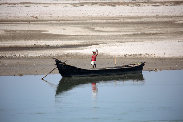 SUNSARI, Jan. 3, 2020 (Xinhua) -- A man prepares to ride a boat to cross Sapta Koshi river at Koshi Tappu Wildlife Reserve in Sunsari, Nepal, Jan. 2, 2020. Koshi Tappu Wildlife Reserve is popular for bird watching and observing the conservation of last remaining population of wild water buffalo, locally known as Arna. (Photo by Sunil Sharma/Xinhua/IANS)