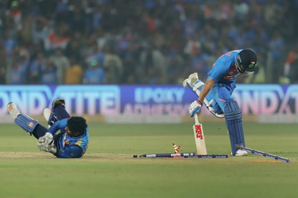 Pune: Sri Lanka's wicket-keeper Kusal Perera dislodge the stumps and completes the run out of India's Virat Kohli during the 3rd T20I match between India and Sri Lanka at the Maharashtra Cricket Association Stadium in Pune on Jan 10, 2020. (Photo: Surjeet Yadav/IANS)
