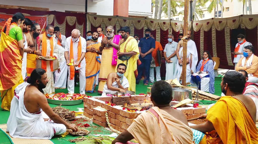 Bengaluru: Karnataka Chief Minister B. S. Yediyurappa participates in Sri Dhanvantari Yagna, seeking divine blessings for the welfare of the world and COVID-19 control, at Shankarmath in Bengaluru on June 16, 2020. Medical Education Minister K. Sudhakar, Tourism Minister C. T. Ravi and Bengaluru South Member of Parliament Tejasvi Surya also participated in the rituals. Wearing masks to protect themselves, Yediyurappa and others donned saffron scarfs as they participated in the Hindu rituals. (Photo: IANS)