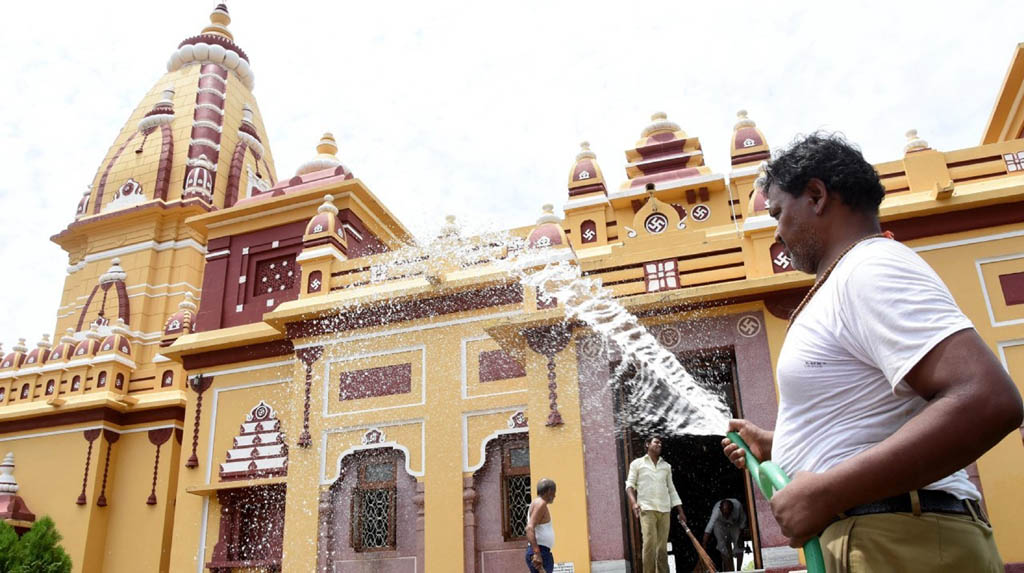 Bhopal: A temple staff washes the Birla temple as it gears up to re-open from June 8; in Bhopal on Jun 6, 2020. (Photo: IANS)