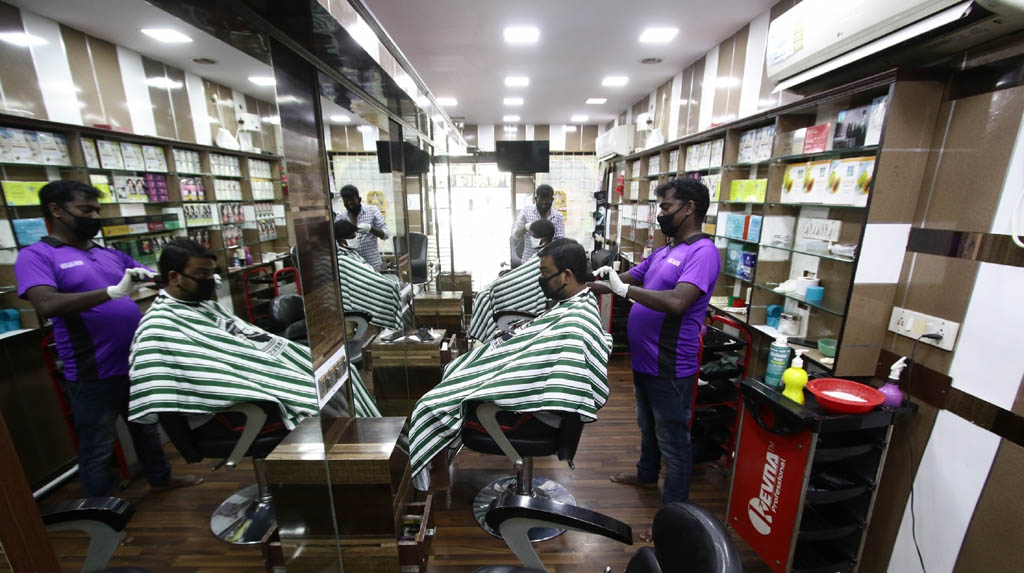Chennai: Hairdressers busy giving hair cut to the customers after salons across Chennai reopened on the first day of the fifth phase of the nationwide lockdown imposed to mitigate the spread of coronavirus, on June 1, 2020. (Photo: IANS)