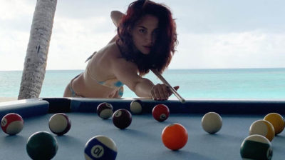 Elli AvrRam plays pool in bikini by the beach